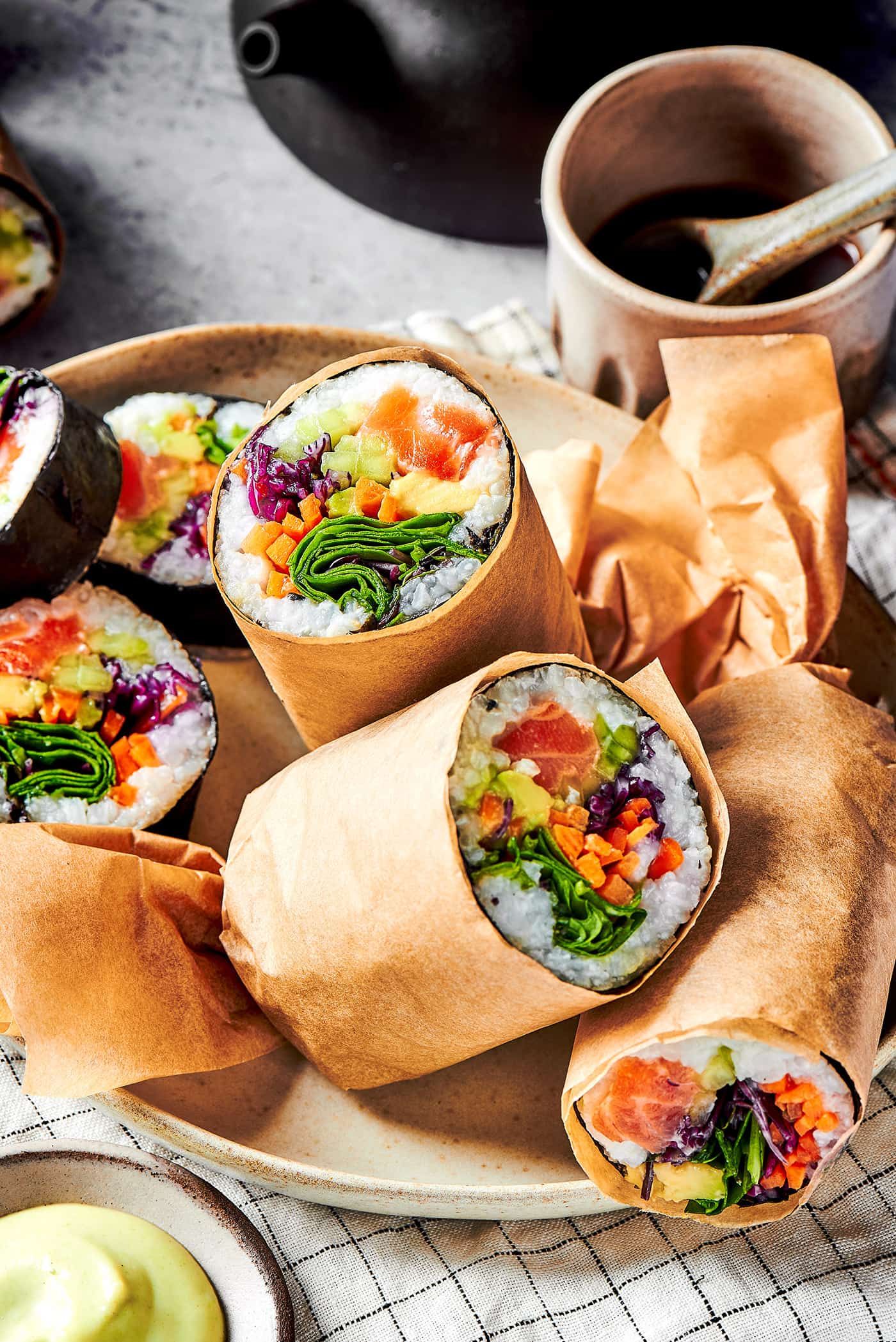 sushi made into burritos, cut, on a platter
