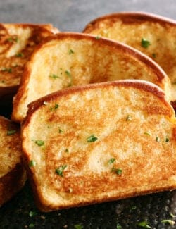 slices of homemade Texas Toast garlic bread on a black pan