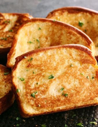 slices of homemade Texas Toast garlic bread on a black pan