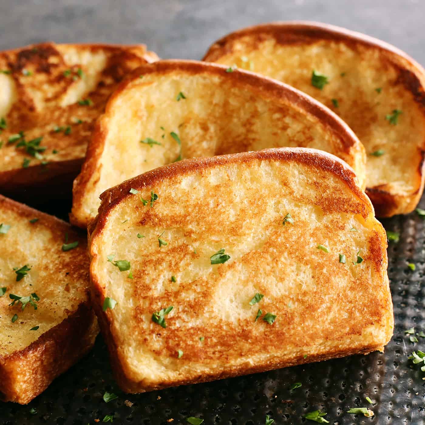 slices of homemade Texas Toast garlic bread on a black pan