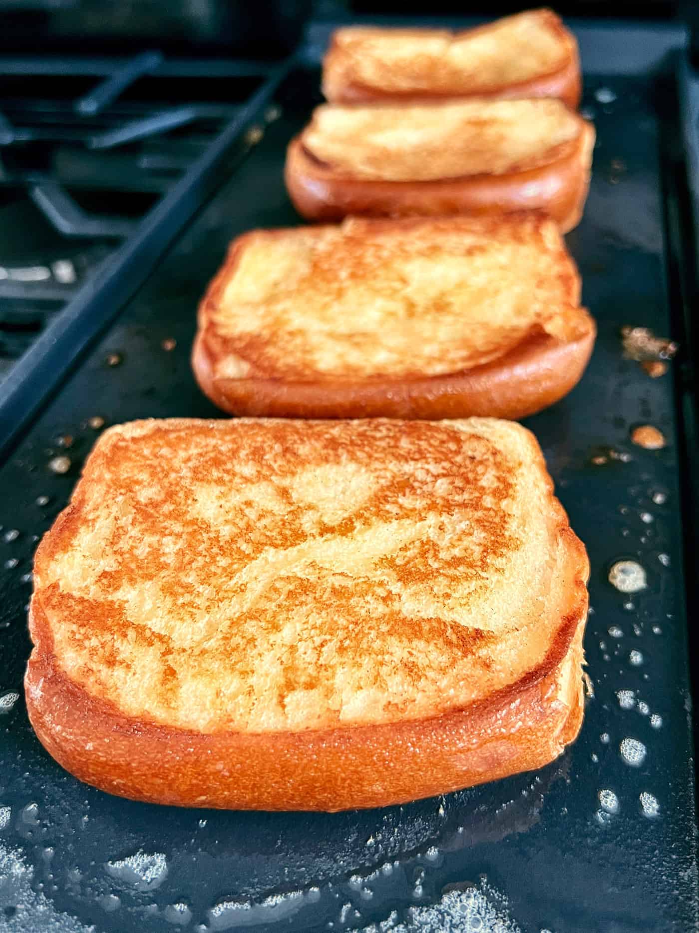 Slices of garlic bread on a griddle
