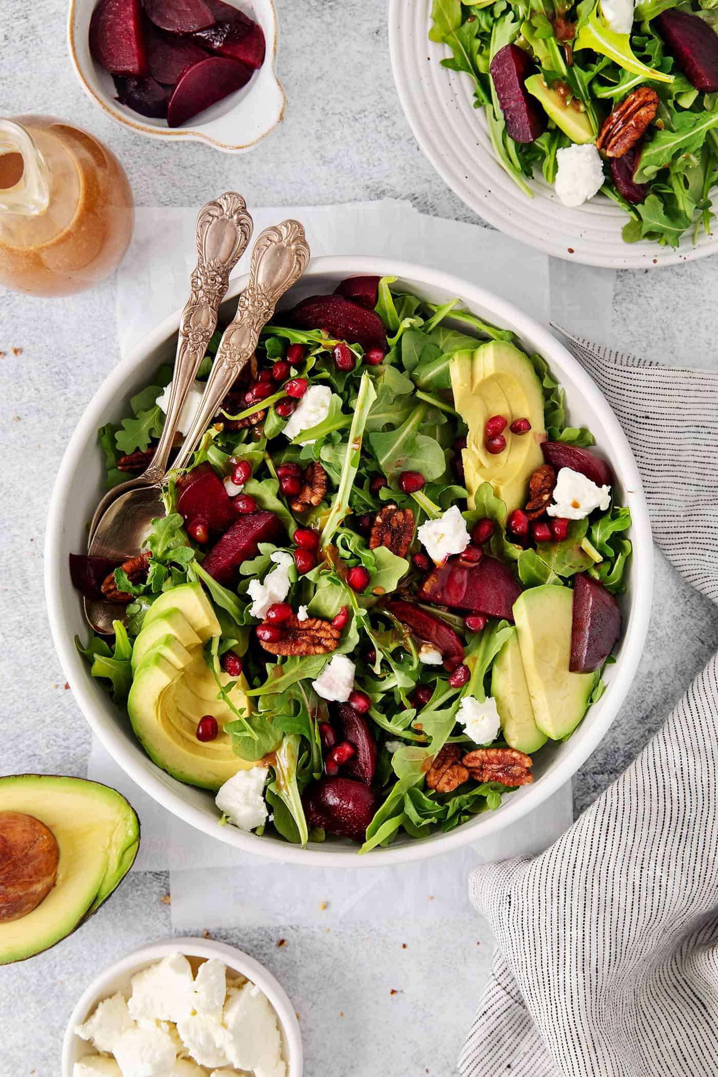 Arugula beet salad topped with pomegranate