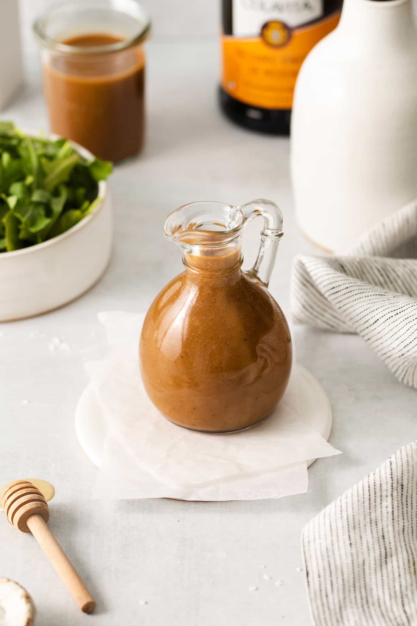 Angled view of a cruet of balsamic vinaigrette