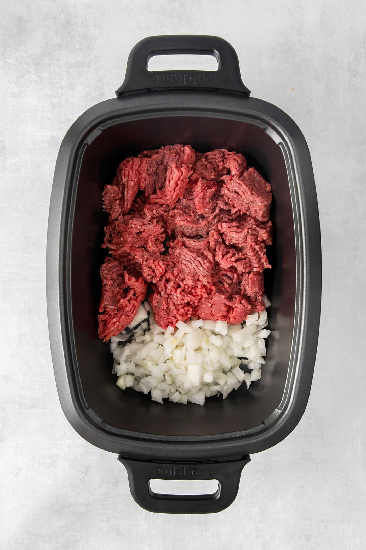 Ground beef and onion in a large slow cooker
