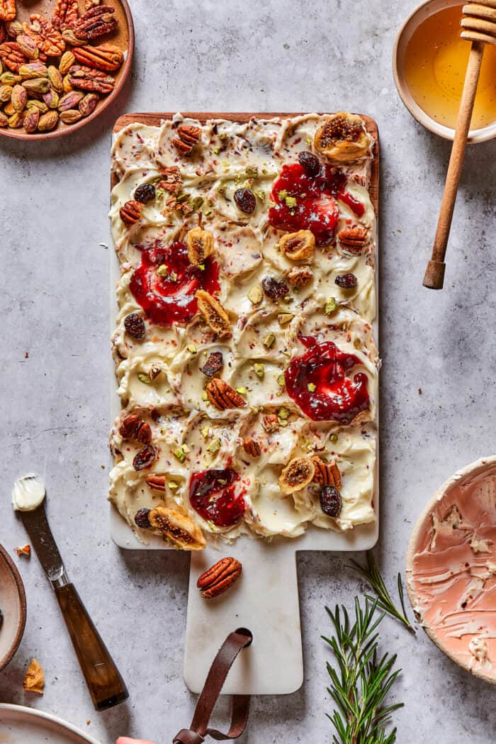 Jam and dried fruits on a butter board