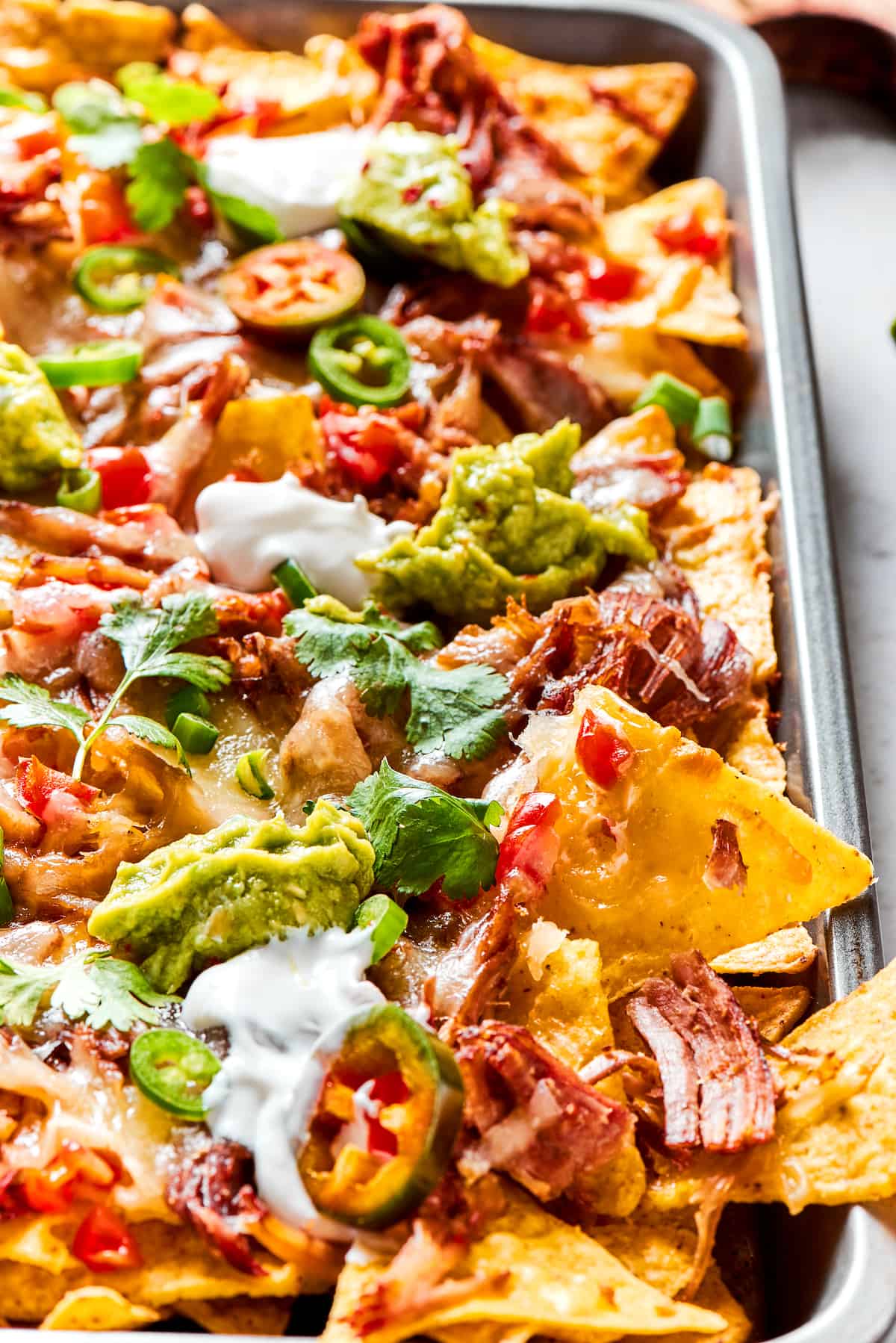 Sheet pan of BBQ pulled pork nachos