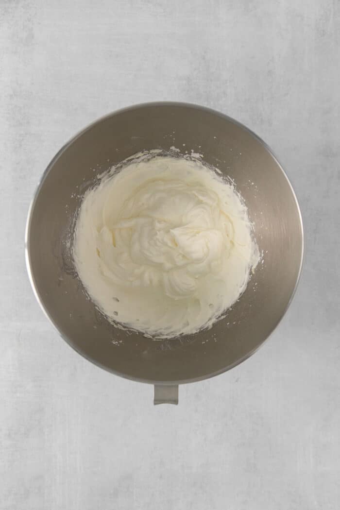 Homemade whipping cream in a mixing bowl