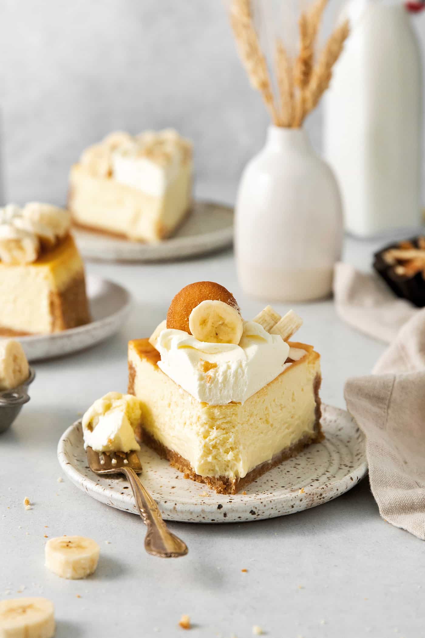 A slice of banana pudding cheesecake on a plate