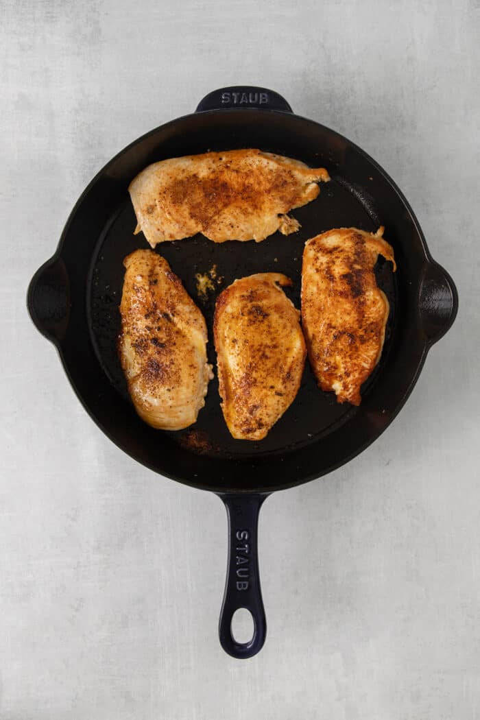 Chicken breasts seared in a skillet