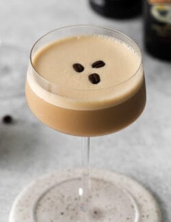 A coffee martini with three coffee beans