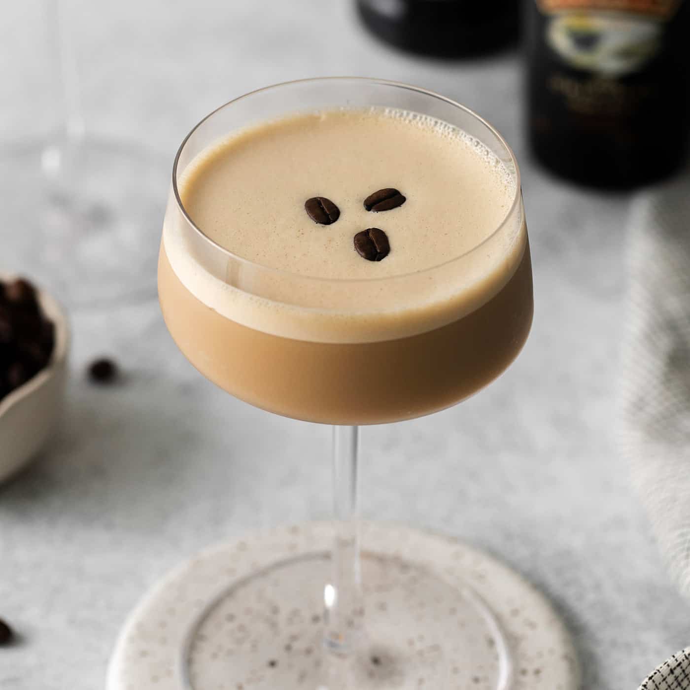 A coffee martini with three coffee beans