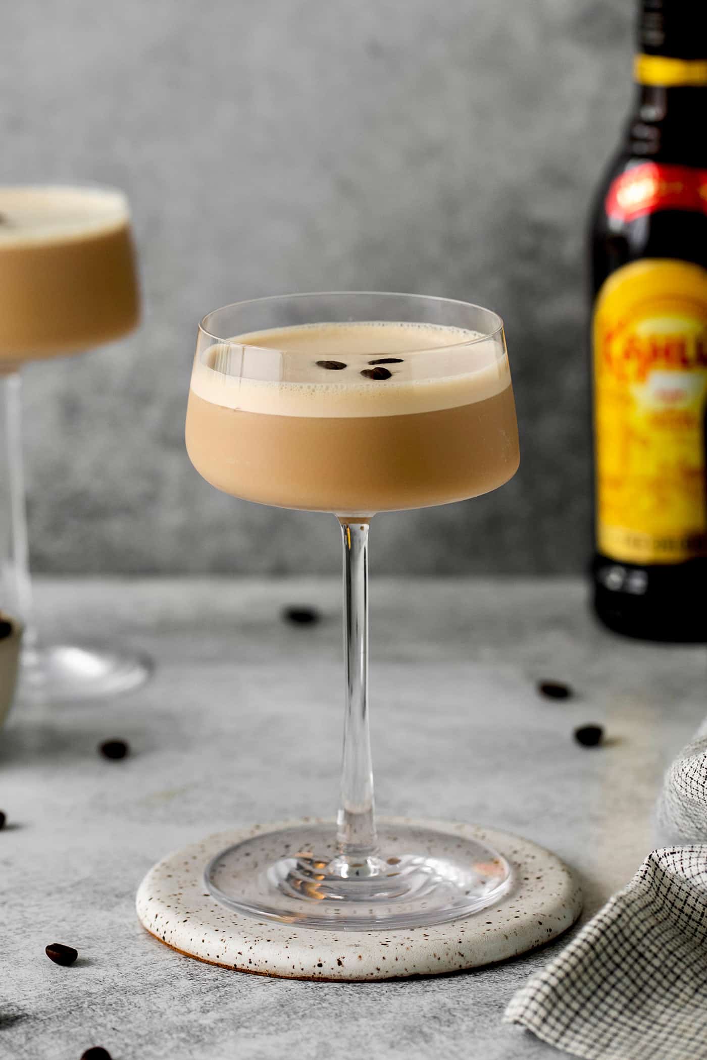 Made with espresso, vodka, and two liqueurs, this Espresso Martini is a strong coffee cocktail that's sure to provide an afternoon boost. Side view of an espresso martini