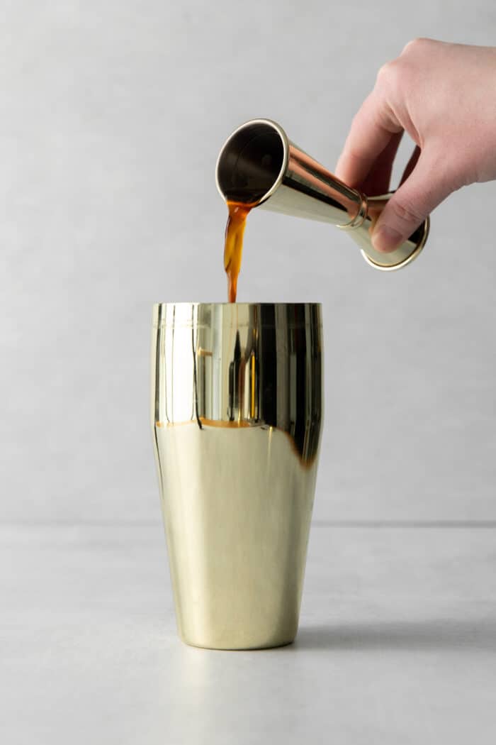 Coffee being poured into a shaker