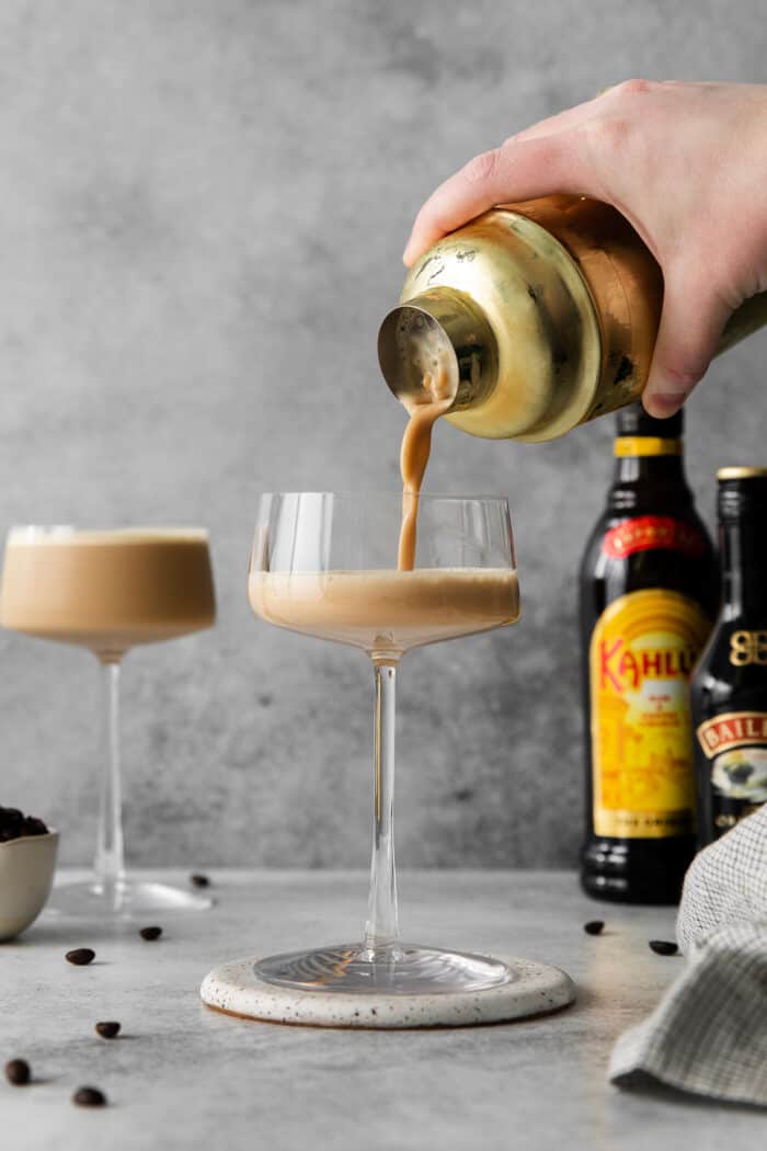 Espresso martini being poured into an espresso glass