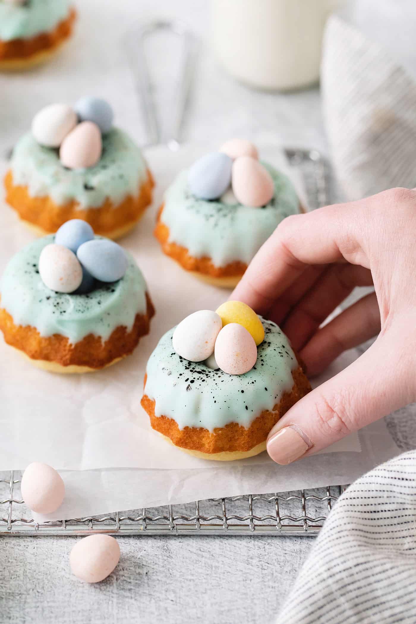 A hand grabbing a mini bundt cake