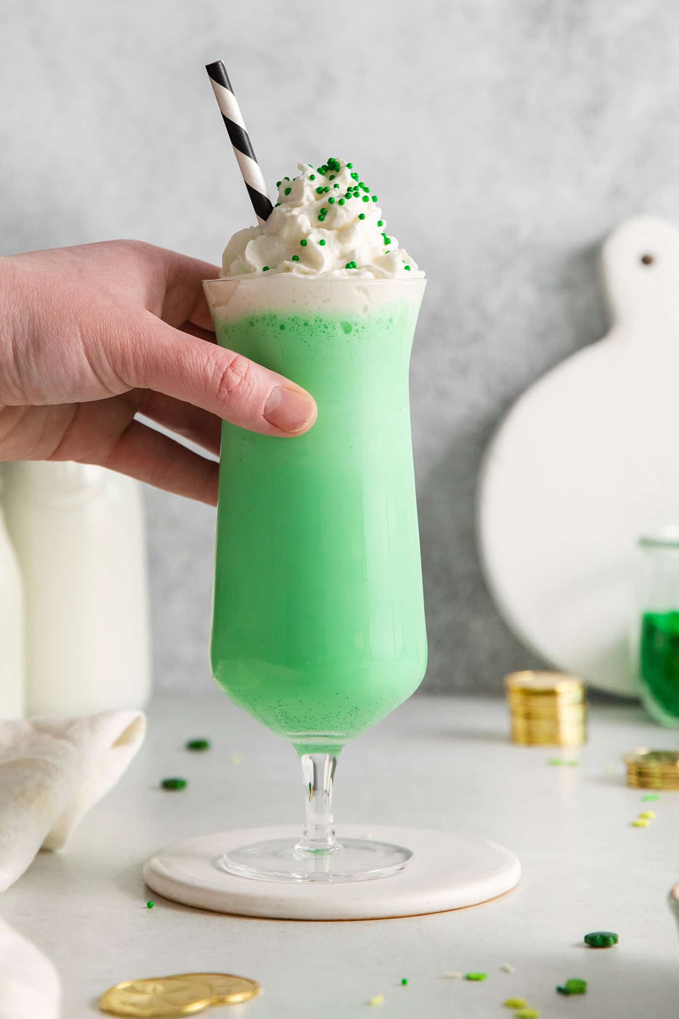 A hand holding a shamrock shake