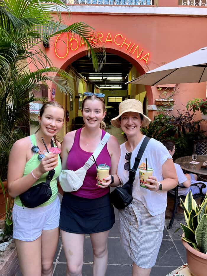 3 girls holding pina colada cocktails at Barrachina restaurant in Old San Juan, Puerto Rico