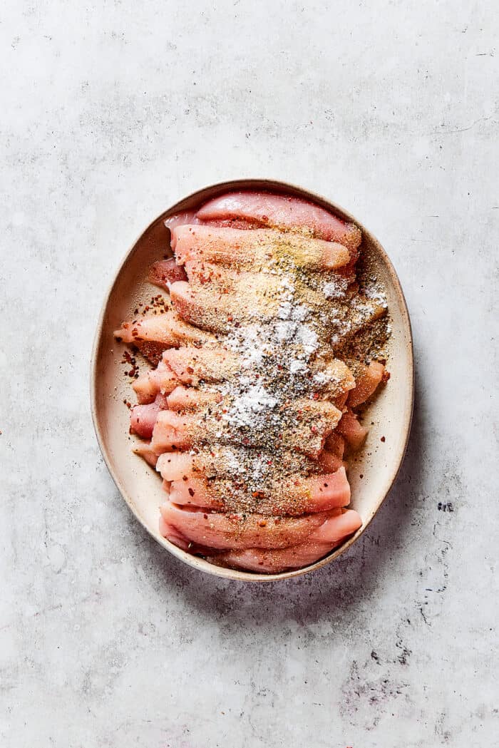 Slices of chicken breast topped with seasonings
