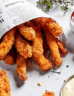 close-up photo of chicken fries in a newspaper cone