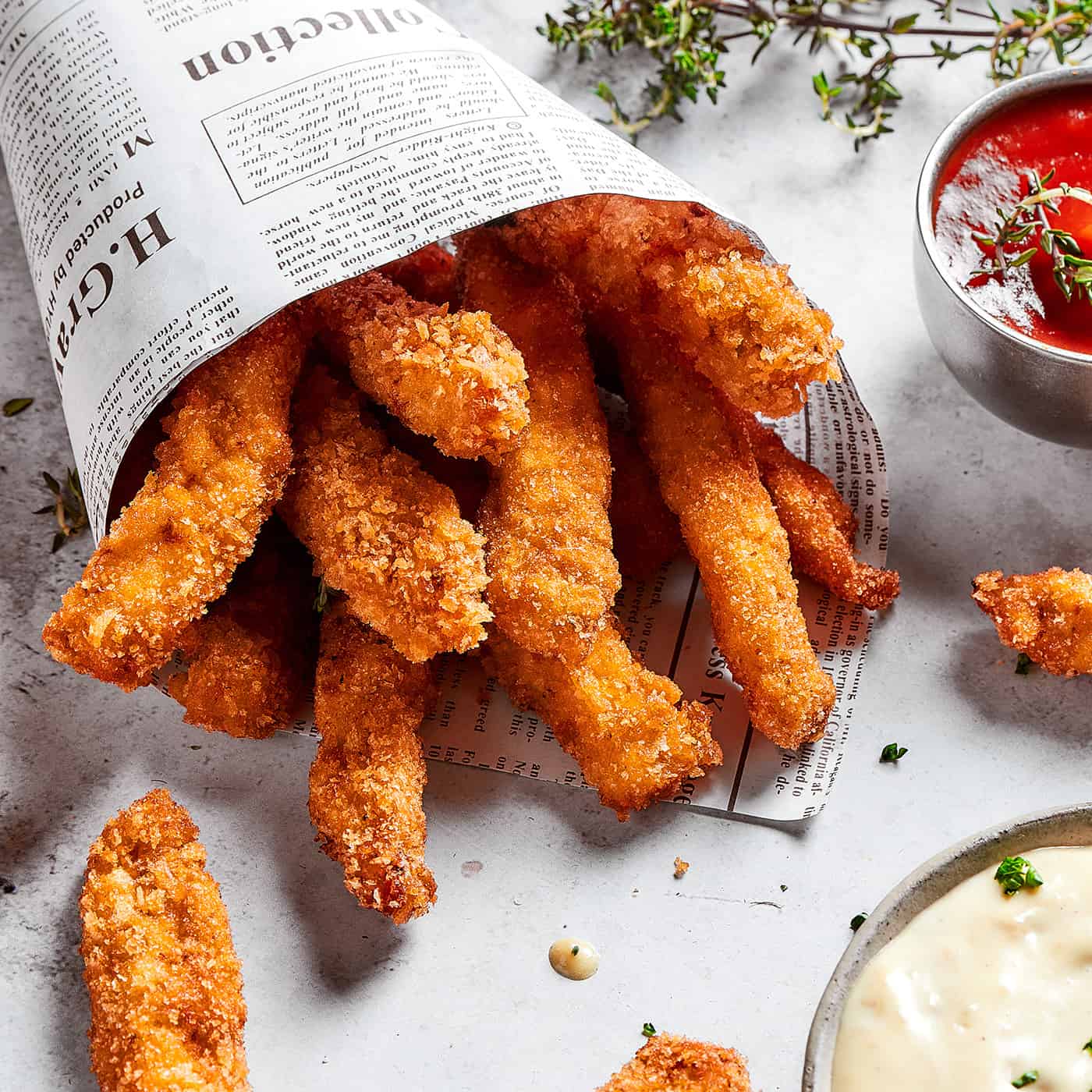 close-up photo of chicken fries in a newspaper cone