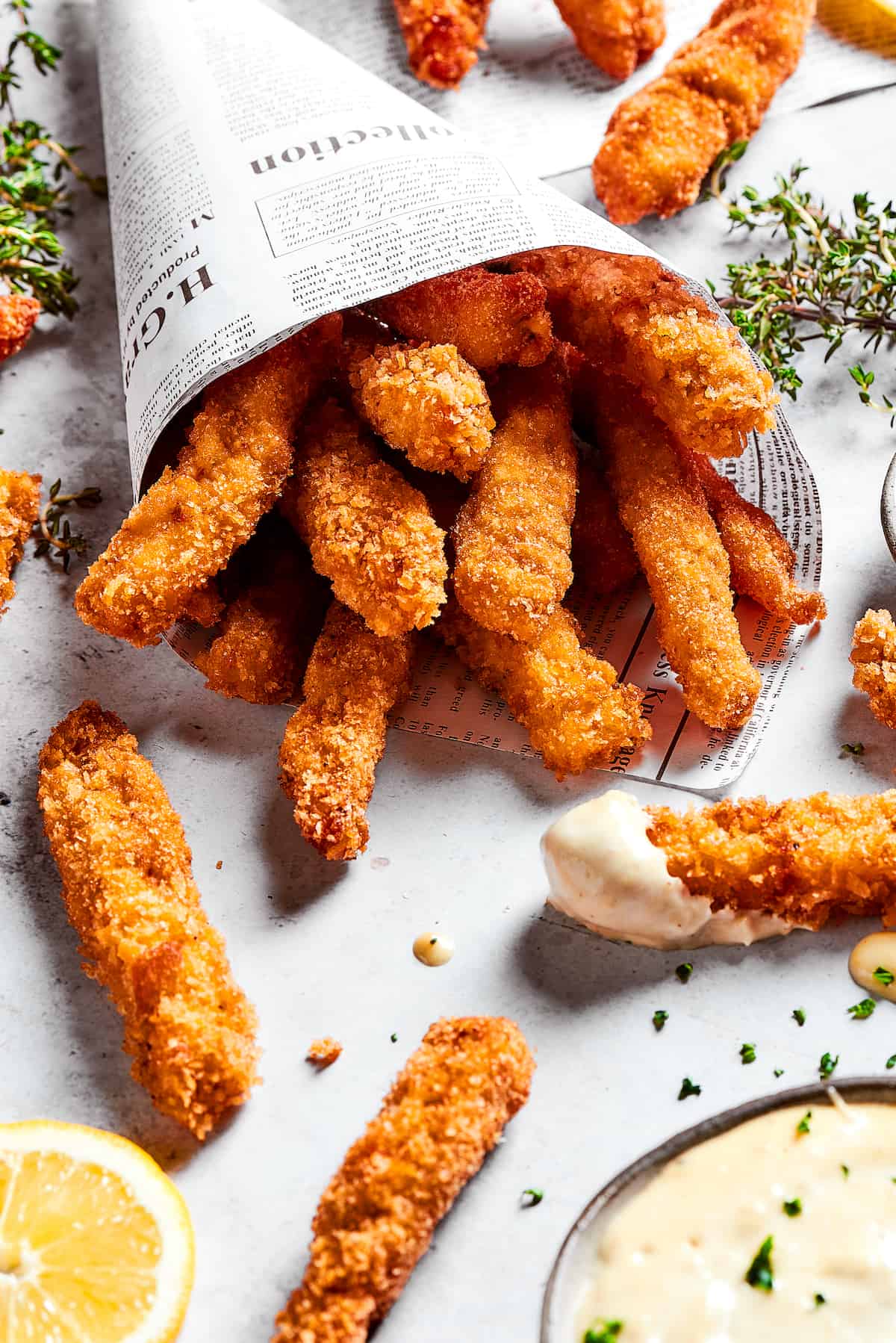 Made with thin, perfectly seasoned strips of chicken, these Chicken Fries are perfect dipped in this tangy roasted garlic aioli. A newspaper funnel of crispy chicken fries