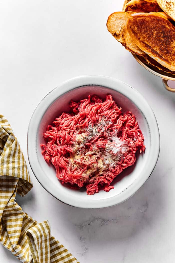 ground beef in a bowl with seasonings