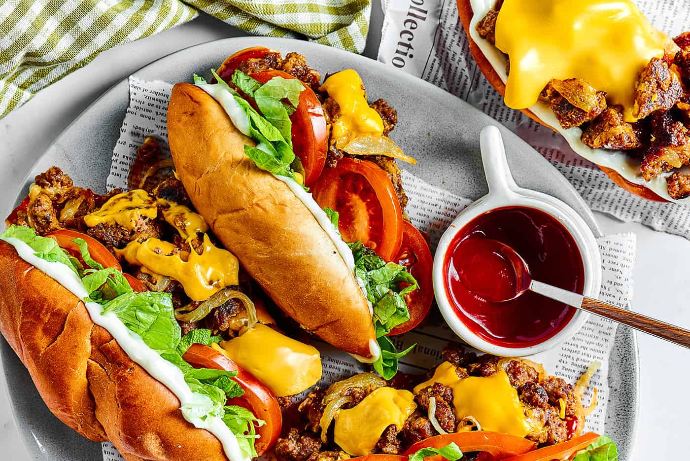 a platter of hoagie buns filled with chopped beef, cheese, lettuce, and cheese