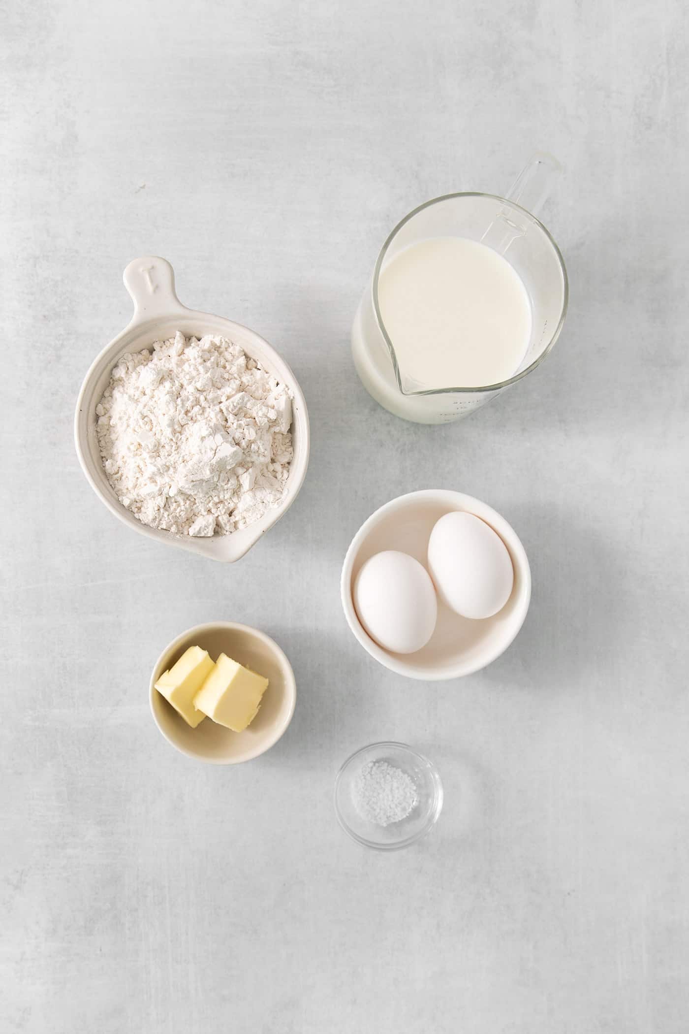 Ingredients for French crepes - eggs, butter, flour, and milk.