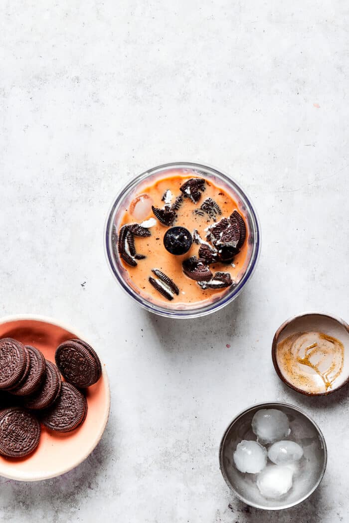 Oreo cookies in a blender with coffee and ice