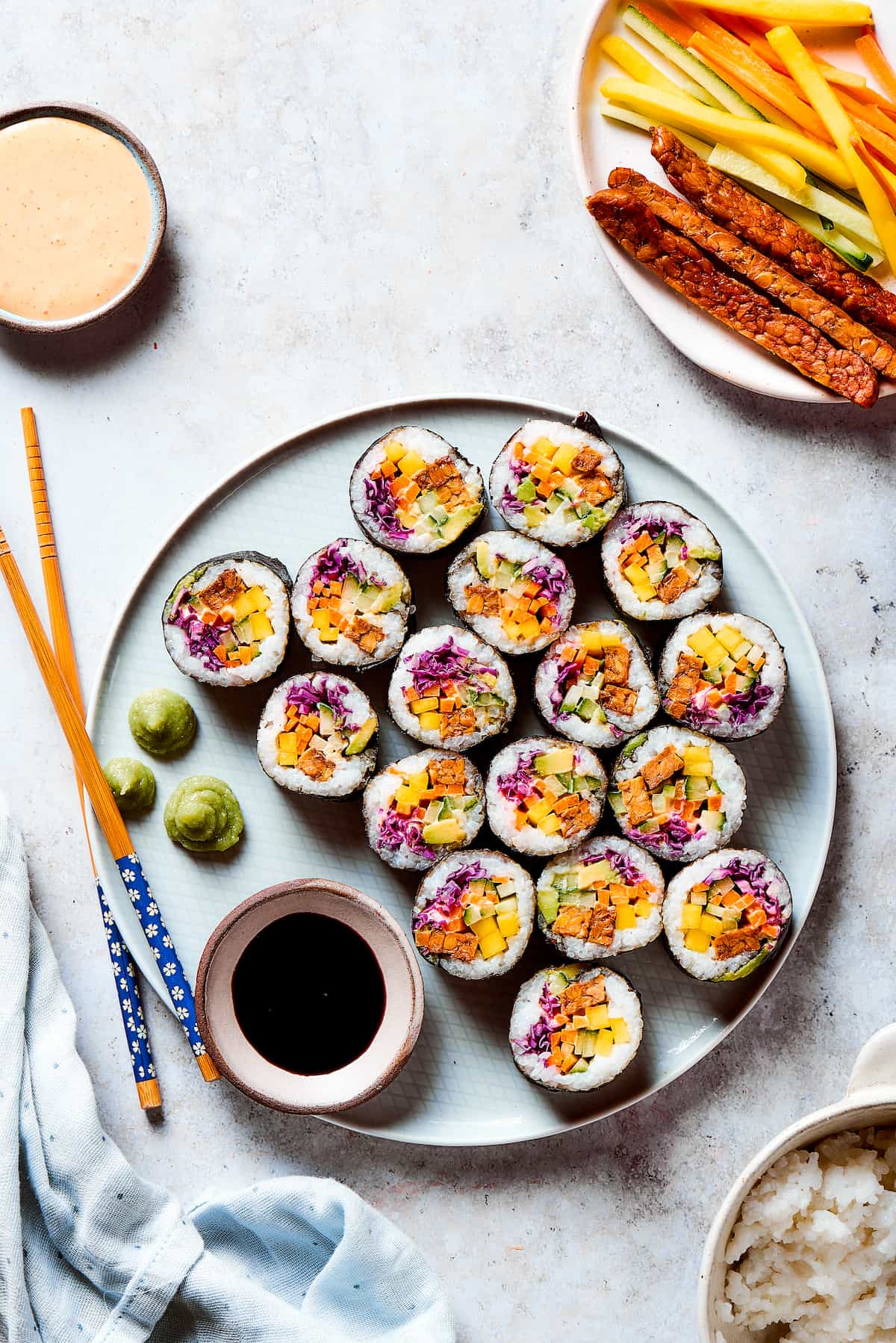 Slices of vegan sushi on a plate with soy sauce