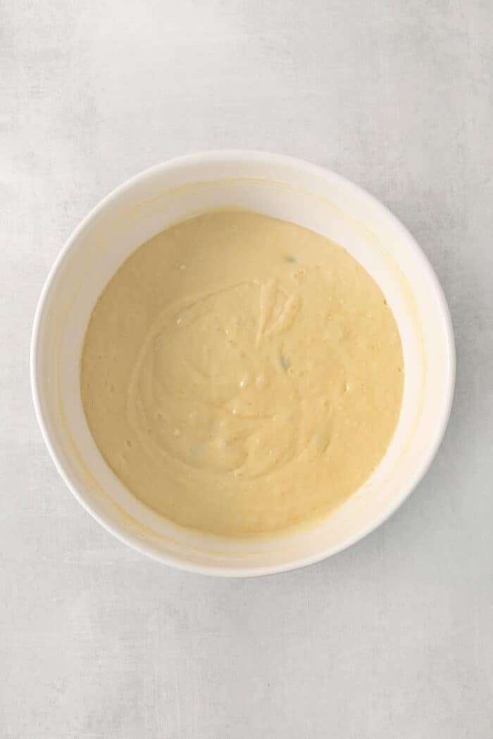 A white bowl of waffle batter.