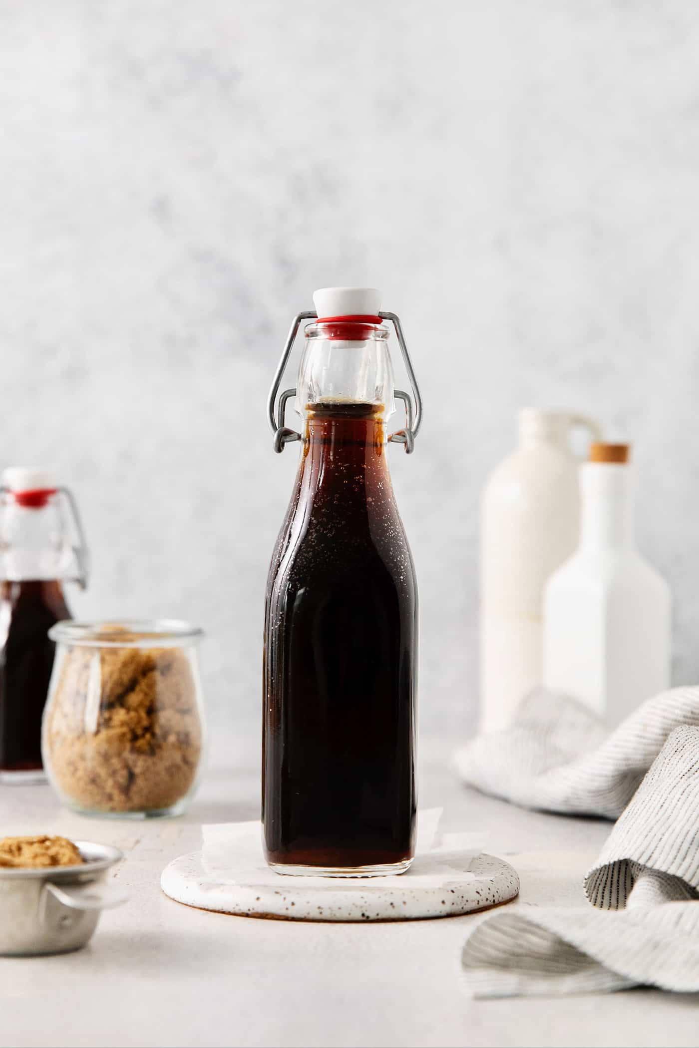 This Brown Sugar Syrup is quick and easy to prepare, with just 3 ingredients - water, brown sugar, and salt. A glass bottle of brown sugar simple syrup