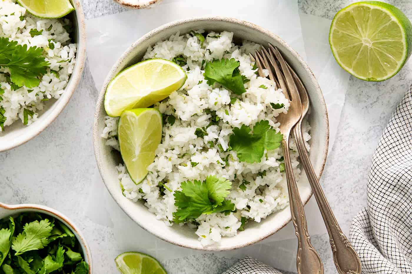 white rice with cilantro and lime in a white bowl