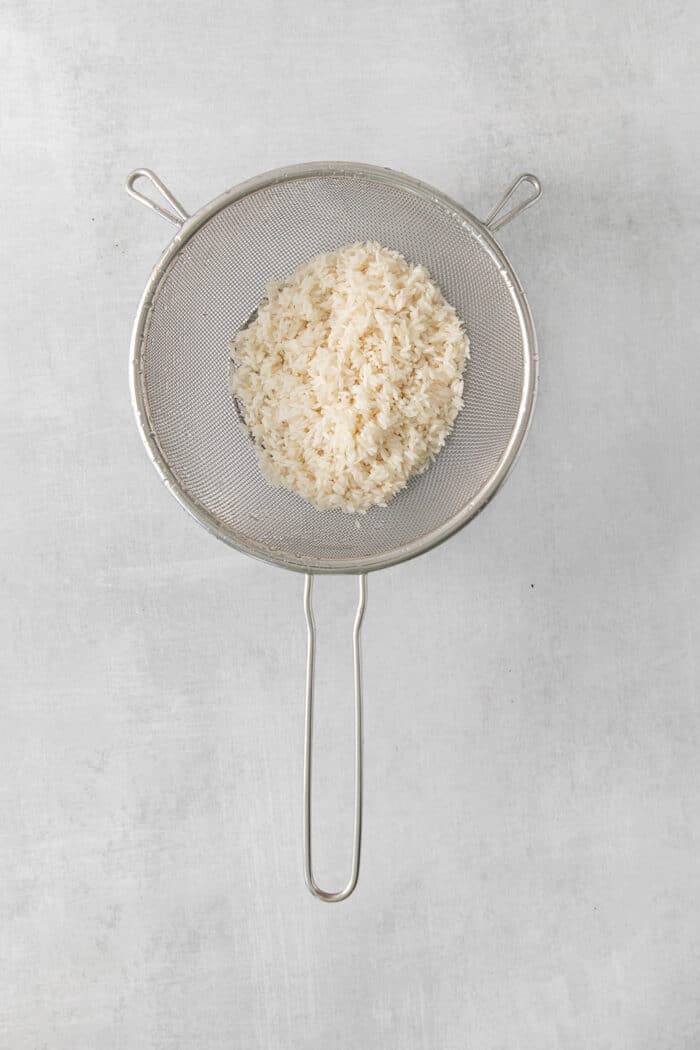 Rice in a mesh strainer
