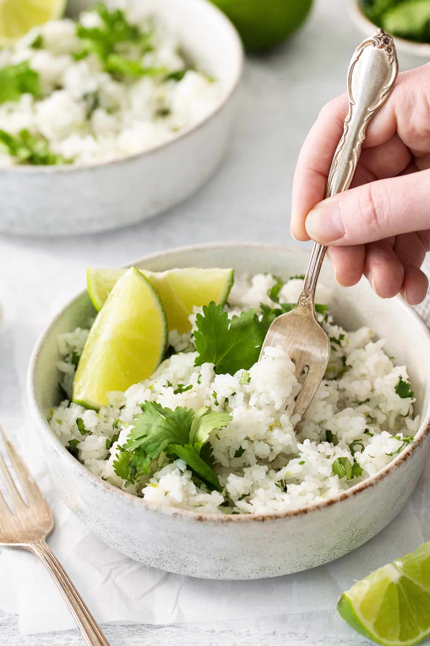 A fork diving into a bowl of cilantro lime rice