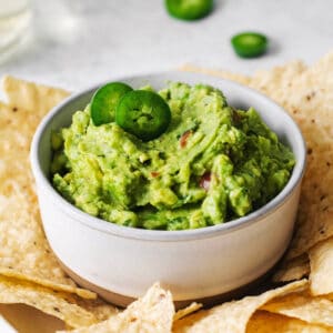 Homemade guacamole in a bowl surrounded by tortilla chips