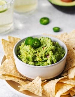 Homemade guacamole in a bowl surrounded by tortilla chips
