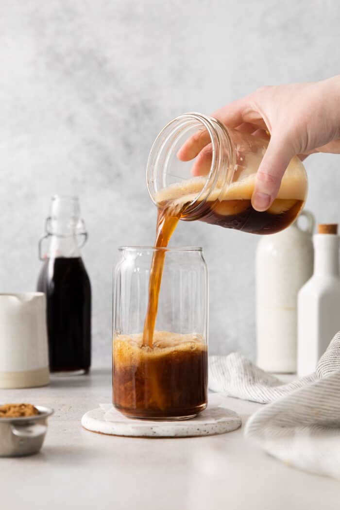 Shaken espresso being poured into a glass