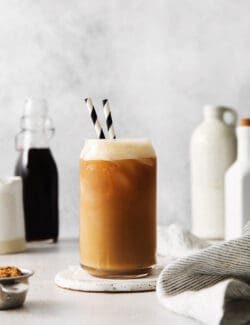 A copycat Starbucks oatmilk shaken espresso in a glass with two straws