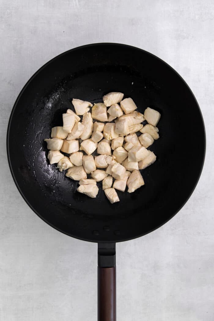 Chunks of chicken breast in a wok