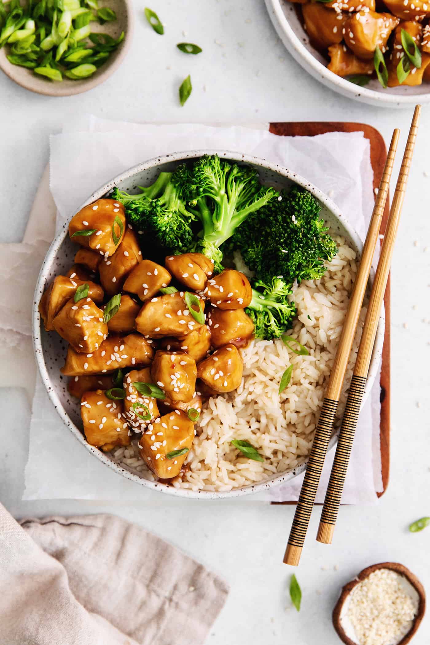 Overhead view of a plate of mandarin chicken with broccoli and rice