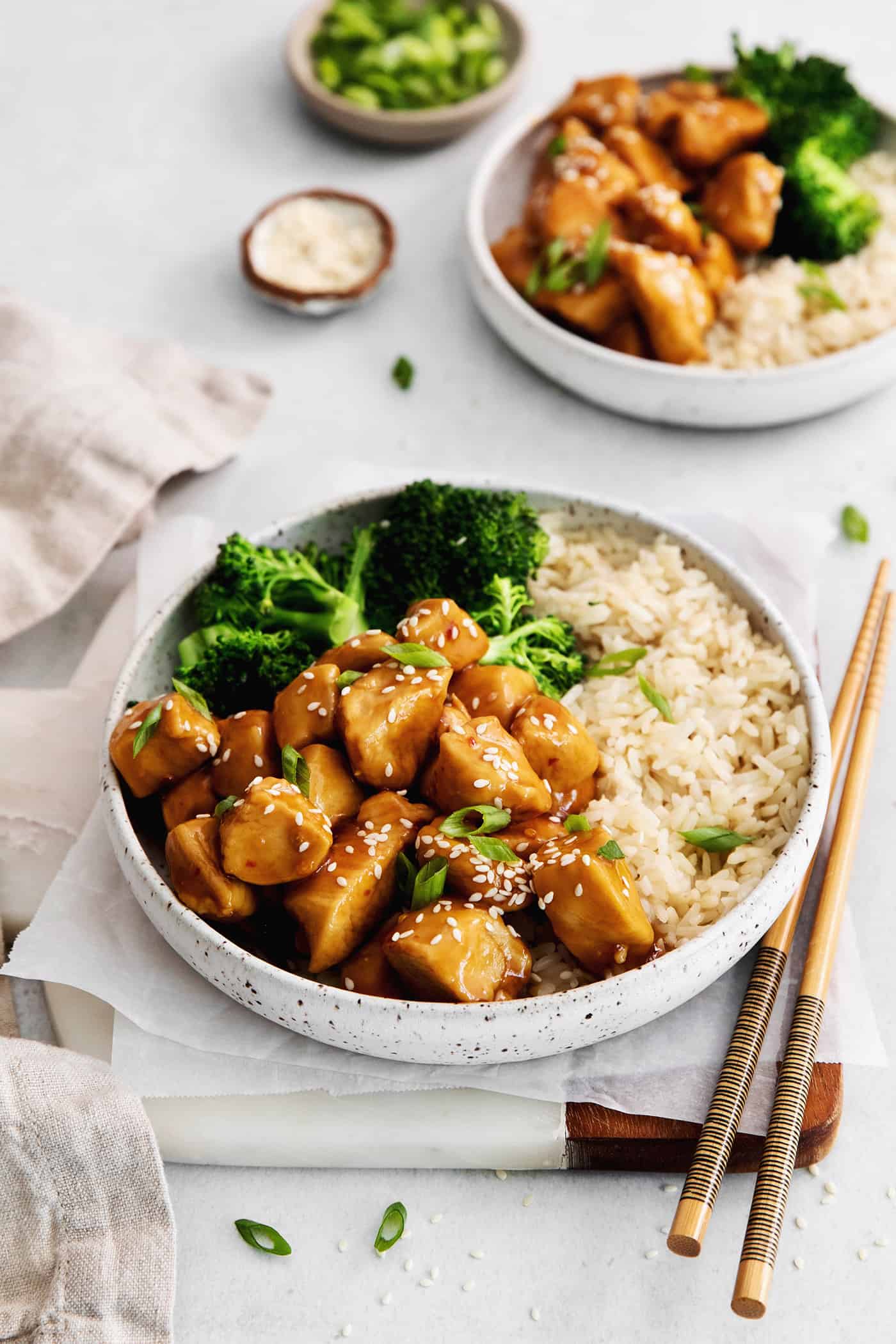 Angled view of two plates of mandarin orange chicken