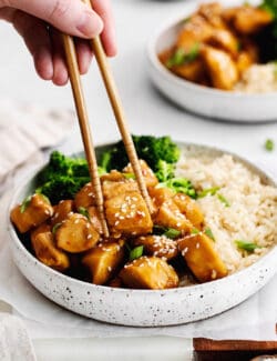 Chopsticks grabbing a piece of mandarin chicken