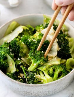 Chopsticks in a bowl of Panda Express super greens