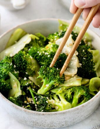 Chopsticks in a bowl of Panda Express super greens