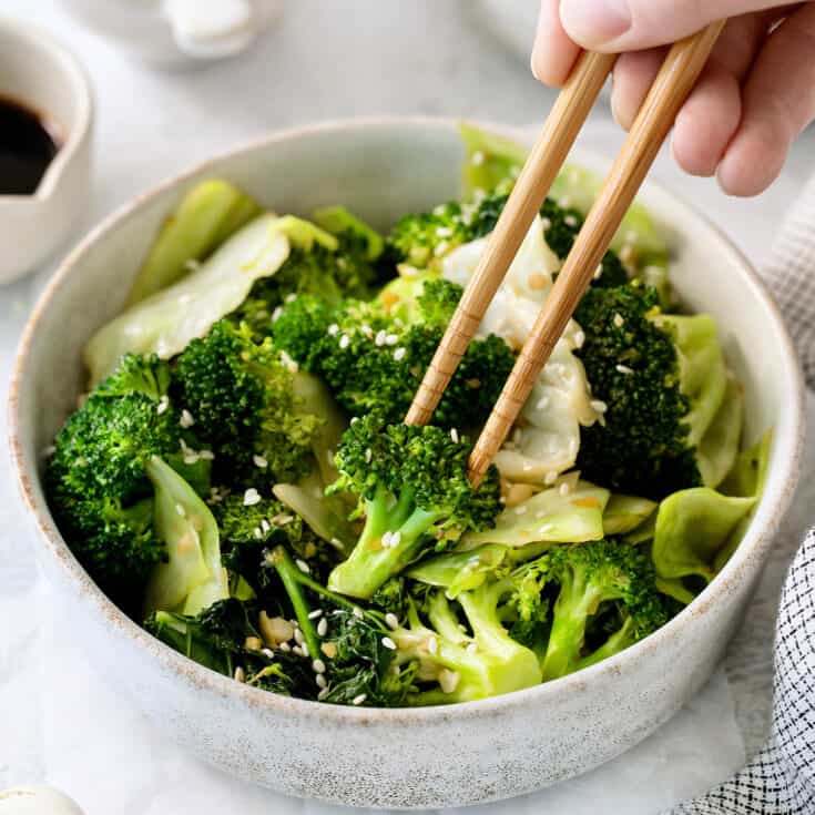 Chopsticks in a bowl of Panda Express super greens