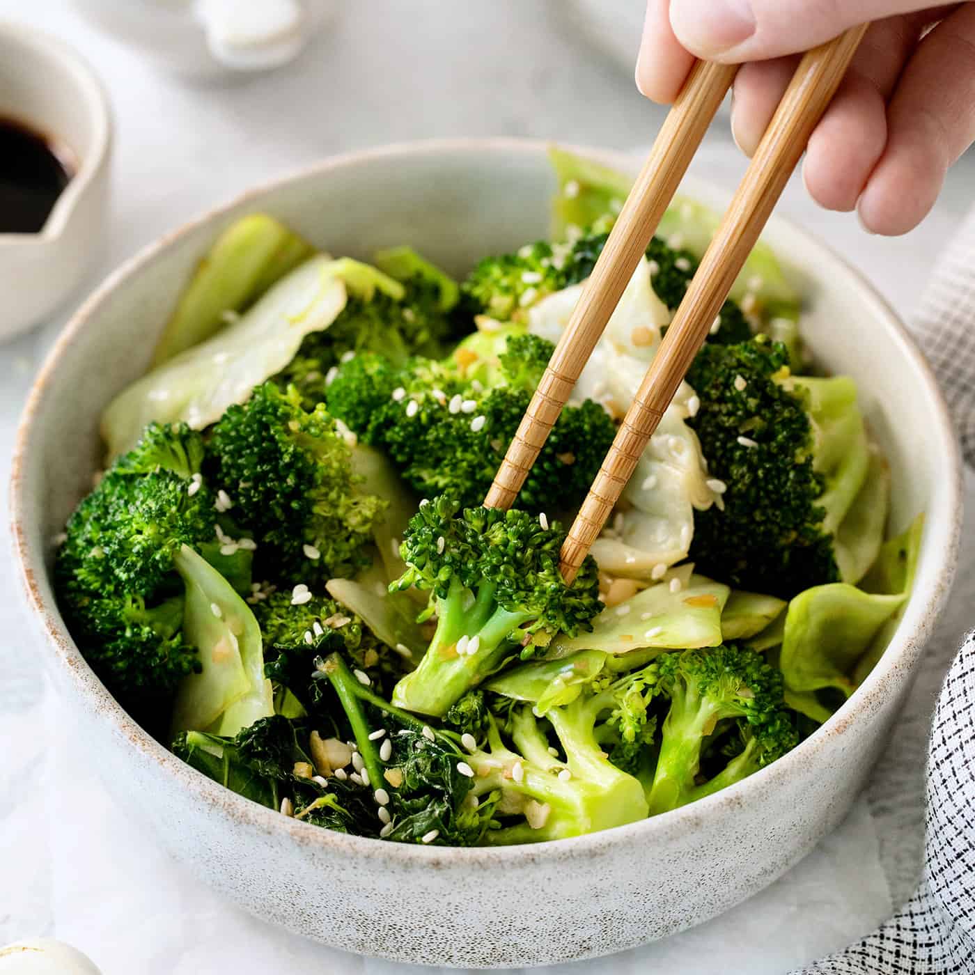 Chopsticks in a bowl of Panda Express super greens