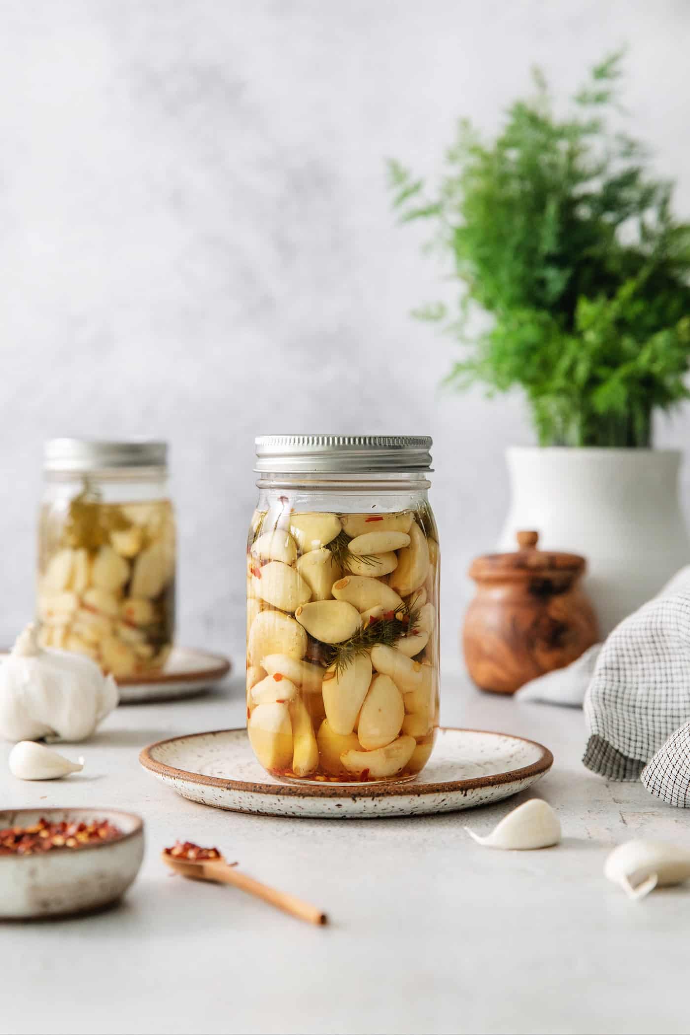 A jar of pickled garlic on a plate