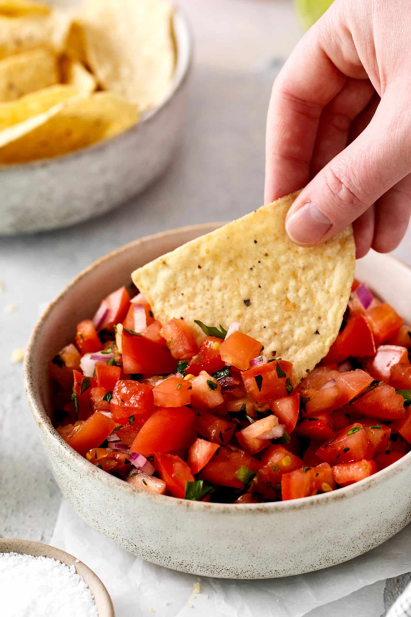 A chip being dipped into pico de gallo