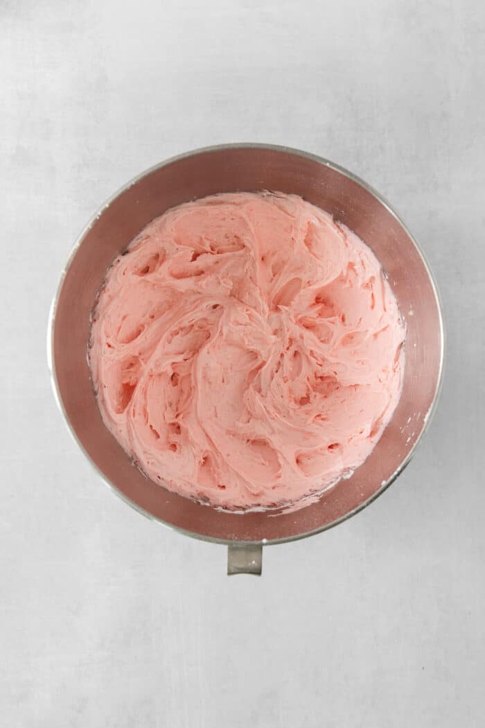 Pink strawberry cupcake batter in a bowl.